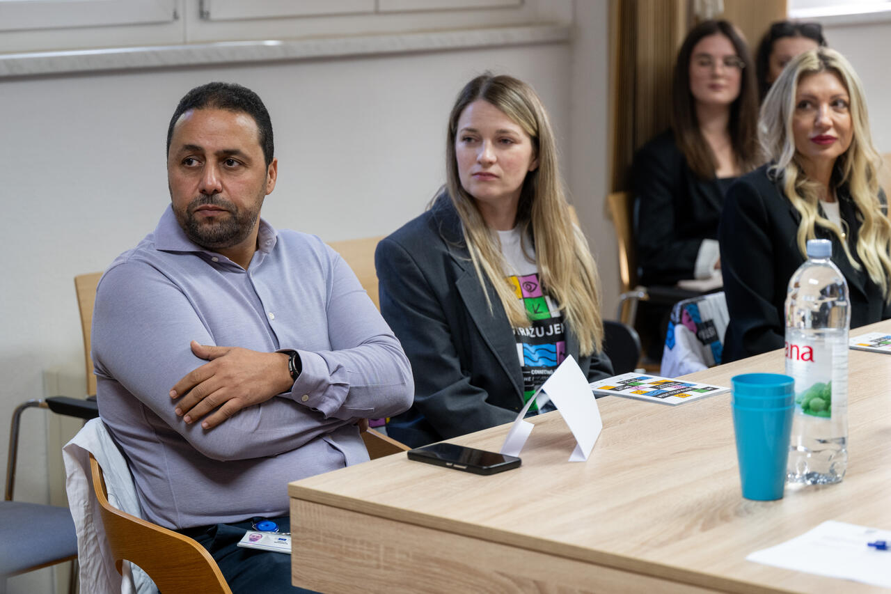 Guests seated at the table following the project presentation.