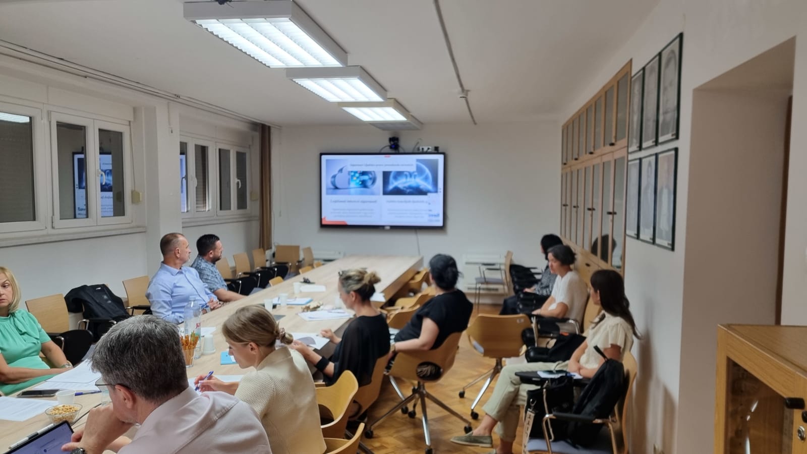 Participants follow a presentation shown on the screen during the round table.